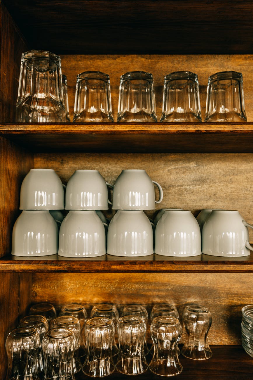 dishes and glasses on kitchen shelves
